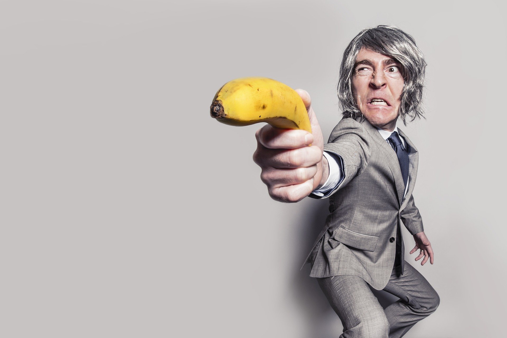 Man in suit holding banana